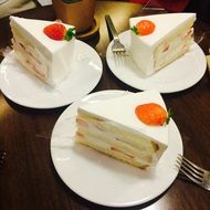 three pieces of cake with strawberries