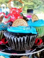 cupcakes with icing decorated with coins