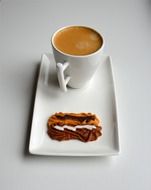 coffee with milk and cookies on a white plate