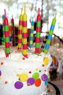 multi-colored candles on a birthday cake