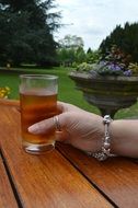 drink glass in hand with braslet and ring