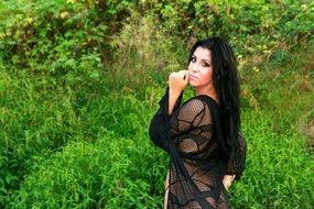 woman with black hair at greenery