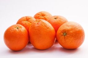 six ripe oranges on white