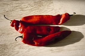 red chili peppers on a wooden table