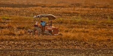 farmer on a tractor on a field