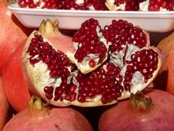 red pomegranate broken up seeds close-up