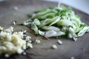 chopped green onions on the board