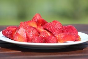 Cut fresh strawberries on a plate