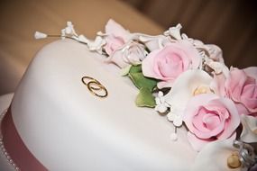 beautiful white wedding cake with rings