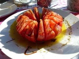 Sliced Spanish tomato with oil and spices