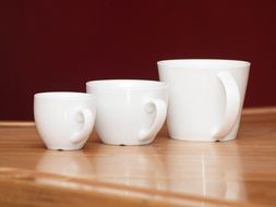 different white cups in a cafe