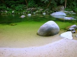 fairytale stones on a background of the pond in the park