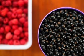 blueberries and raspberries lie in a plates