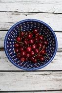 ripe cherry in a blue bowl