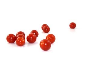 small cherry tomatoes on a white surface