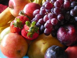 grapes, apples, strawberries and blue plums