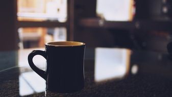 coffee in a black cup on the table