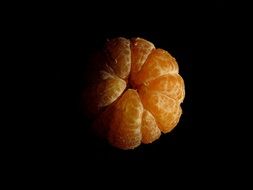 peeled tangerine photo in the dark