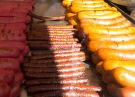 many sausages on a grill