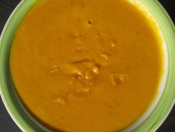 pumpkin cream soup in a green plate