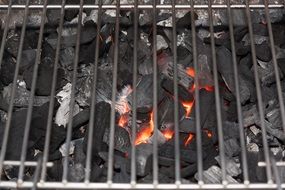 burning coals under the grate