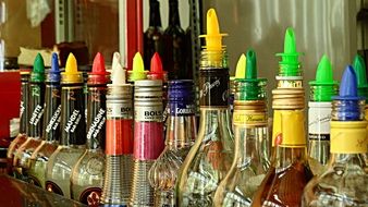 variety of colorful cocktail bottles in the bar