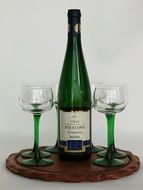 a bottle wine and wine glasses on a tray