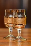 two festive glasses with gold