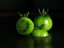 green tomato on a dark background