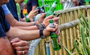 beer bottles in the hands of men at a party