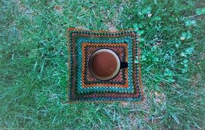 coffee in a cup on green grass