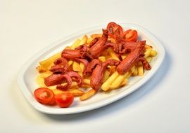 fried potato with sausages and tomato