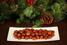 Brown chestnuts on a white plate