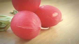 three red radishes on the table