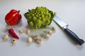 romanesca cauliflower, red pepper, red chile, button mushrooms and chef's knife