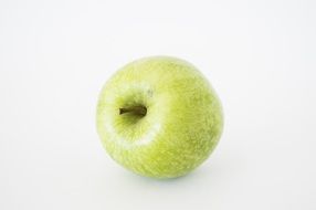 perfect green apple on white surface