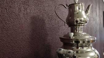 silver samovar and wall