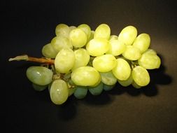 white grapes on dark surface