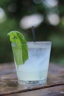 Alcohol cocktail in the glass on the table on a blurred background