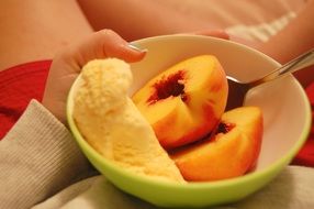 fruit ice cream and peaches in a bowl