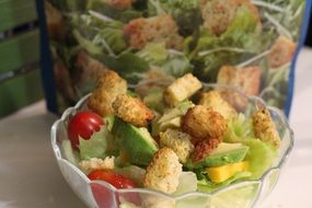 Salad with the tomatoes in the glass bowl