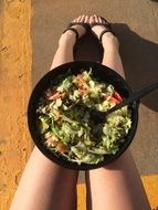 Salad in the bowl on the legs