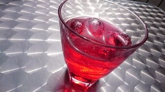 Iced cold alcohol red drink in the glass