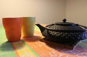 colored cups and cast iron kettle