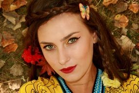 portrait of the beautiful girl on a background of autumn leaves