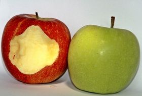 whole green apple and a bitten red apple