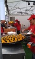 cooking paella in a huge pan