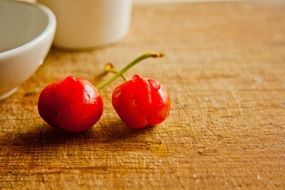 two cherries on wooden table