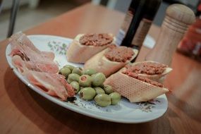 Baguette with olives on a plate