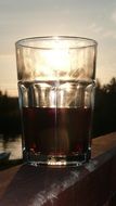 closeup picture of drink in a glass at the sunlight